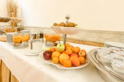 a table with a plate of fruit on it at Hosianum Palace in Rome