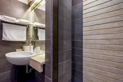 a bathroom with a sink and a toilet at HT Romeo Al Babuino in Rome