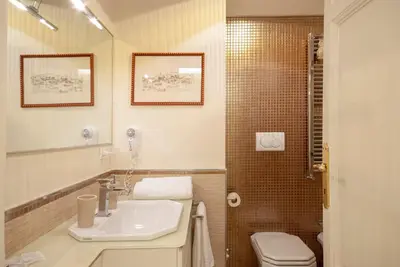 a bathroom with a sink and a toilet at Bea Suites Luxury Rooms in Rome