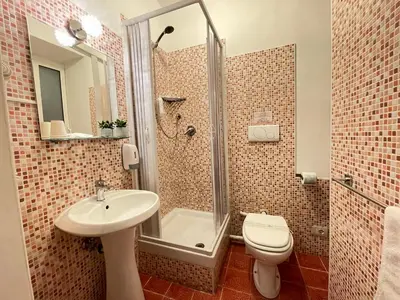 a bathroom with a shower and a sink and a toilet at Roman Holidays Rooms Otranto in Rome