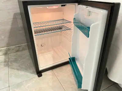 an empty refrigerator with its door open in a kitchen at Roman Holidays Rooms Otranto in Rome