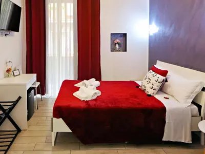 a bedroom with a bed with a red blanket at Relais Villa Borghese in Rome