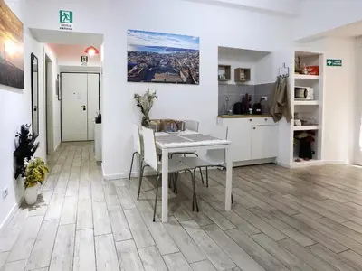 a kitchen and dining room with a table and chairs at Relais Villa Borghese in Rome