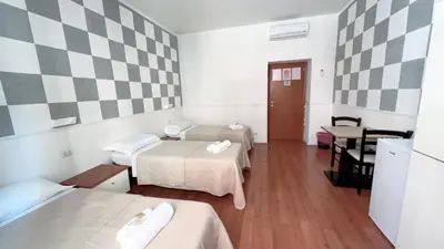 a bedroom with a bed and a table and a window at Hi Termini in Rome