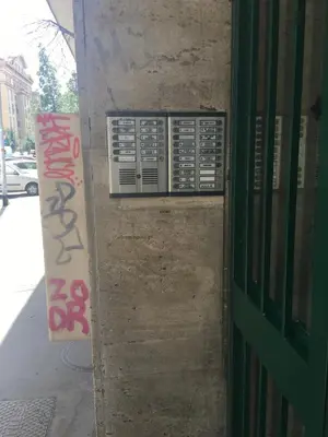 a door to a building with a sign on it at Rhome Suites in Rome