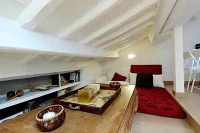 a living room with a couch and a table at Pantheon Charming Attic | Romeloft in Rome