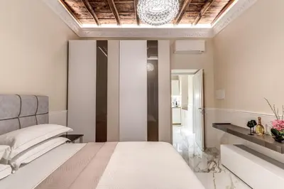 a bedroom with a bed and a table and chairs at Rome55 - Piazza di Spagna in Rome