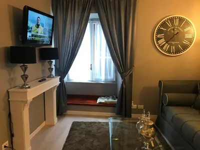 a living room with a clock and a couch at Di Rienzo Residences in Rome
