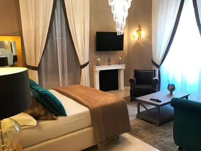 a bedroom with a bed and a couch and a chair at Di Rienzo Residences in Rome