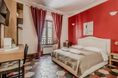 a bedroom with red walls and a bed in a room at Ariana Luxury Guest House in Rome