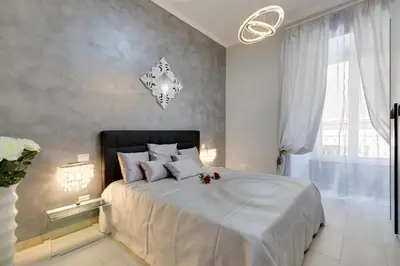 a bedroom with a large bed with flowers on it at New In! Sophie at Colosseum in Rome