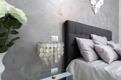 a bedroom with a bed and a vase with white pillows at New In! Sophie at Colosseum in Rome