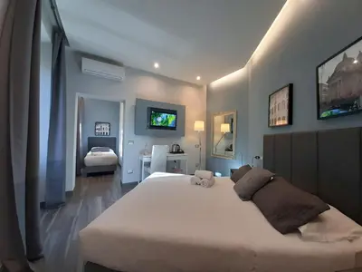 a bedroom with a large white bed in a room at B&B Home 77 in Rome