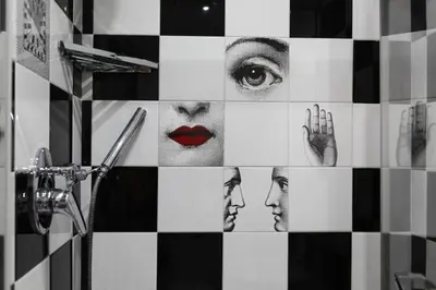 a bathroom with a black and white checkered wall at Vatican Catone Apartments in Rome