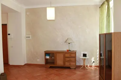 a room with a table and a lamp on a tiled floor at A Casa Di Magda (Al centro di Roma) in Rome