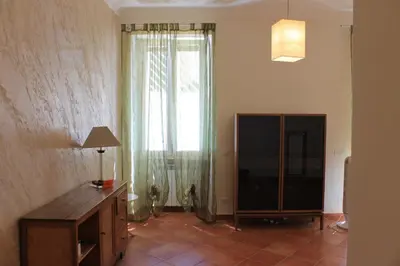 a living room with a large window and a television at A Casa Di Magda (Al centro di Roma) in Rome
