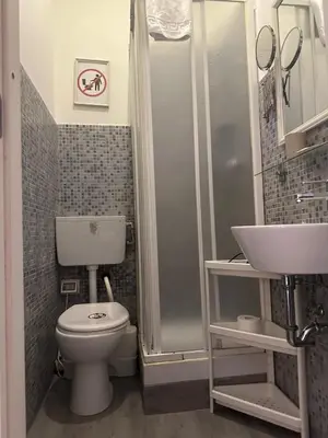 a bathroom with a toilet and a shower and a sink at Guest House Relais Indipendenza in Rome