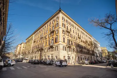 a large building with cars parked in front of it at A Peace Of Rome B&B in Rome