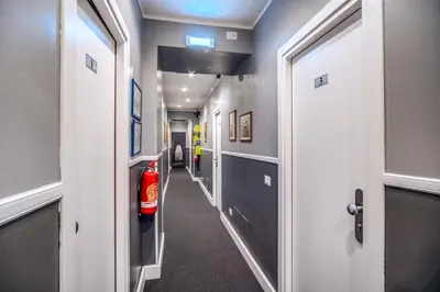 a hallway with a fire extinguisher in a room at A Peace Of Rome B&B in Rome