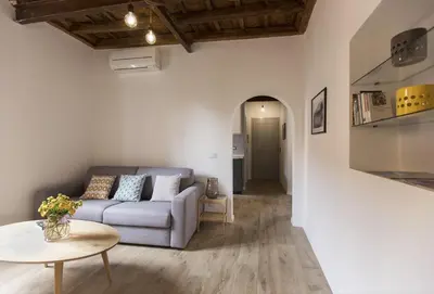 a living room with a couch and a table at Cozy apartment in via degli Spagnoli - FromHometoRome in Rome