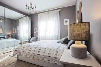 a bedroom with a bed and a lamp on a table at Vatican's Sight in Rome