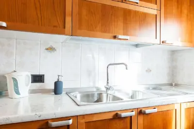 a kitchen with a sink and wooden cabinets at Vatican's Sight in Rome