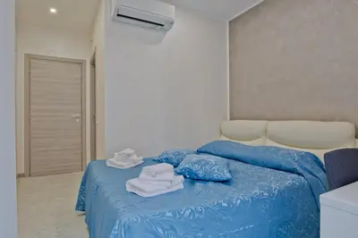 a bedroom with a blue bed with towels on it at Oscar 2 in Rome