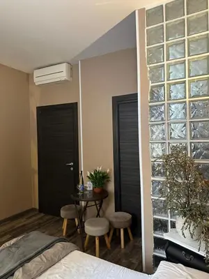 a bedroom with black doors and a table and chairs at Candia Rooms in Rome