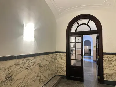 a hallway with a door and a window at Candia Rooms in Rome