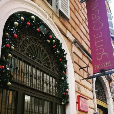 a building with christmas decorations on the front of it at Suite Dal Conte in Rome