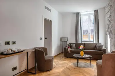 a living room with a couch and a table at Navona Essence Hotel in Rome
