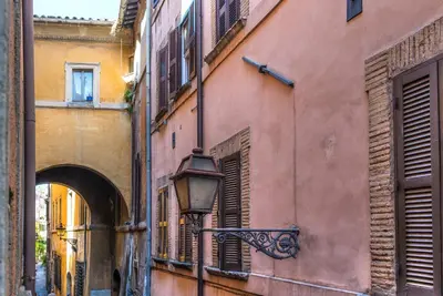 an alley with a street light next to a building at Navona Essence Hotel in Rome