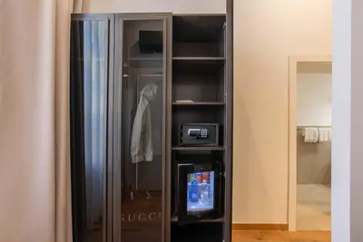 a black closet with a tv in it at Navona Essence Hotel in Rome