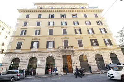 a large yellow building with people walking in front of it at Aelius in Rome