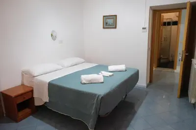 a bedroom with a white bed with a blanket at Andromeda by Gialel in Rome