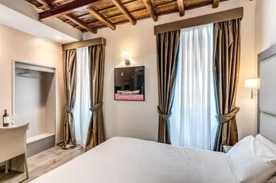 a bedroom with a bed and a window at Reginella Suites in Rome