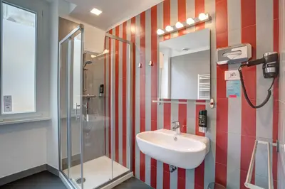 a bathroom with a sink and a shower at MEININGER Roma Termini in Rome