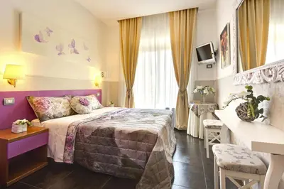 a hotel room with a bed and a desk at Hotel Marcantonio in Rome