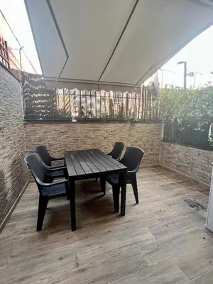 a wooden table and chairs on a patio at Ponte Milvio - Flat with terrace in Rome