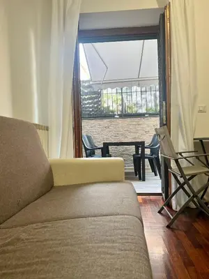 a living room with a couch and a view of the water at Ponte Milvio - Flat with terrace in Rome