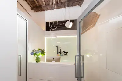 a room with a glass door and a vase of flowers at First Floor - Boutique Hotel in Rome