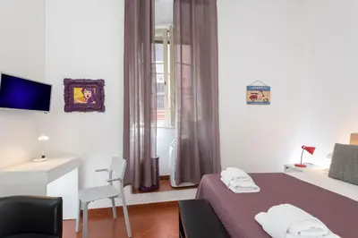 a small bedroom with a bed and a window at Opera House in Rome