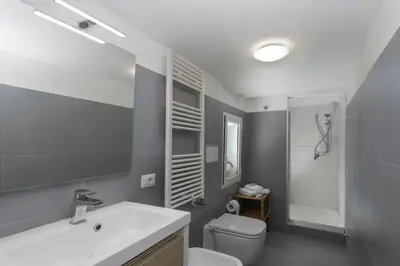 a bathroom with a sink and a toilet and a mirror at Opera House in Rome