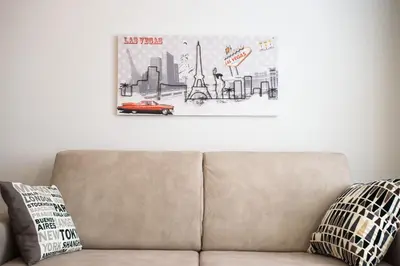 a couch in a living room with a picture on the wall at Enjoy Ponte Lungo in Rome