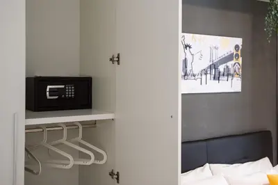 a bedroom with a bed and a tv on a shelf at Enjoy Ponte Lungo in Rome