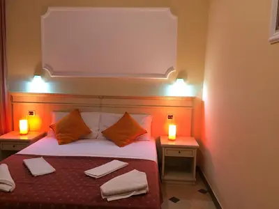 a bedroom with a bed with two lights on it at Affittacamere Alex in Rome