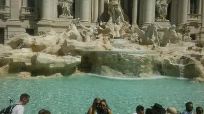 a group of people standing in front of a fountain at Affittacamere Alex in Rome