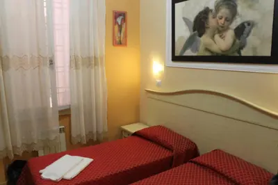 a bedroom with a bed and a picture on the wall at Affittacamere Alex in Rome