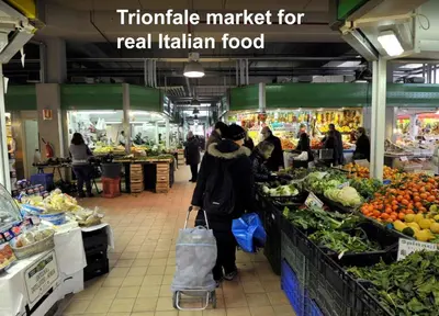 a group of people standing in a produce market at Spartacus Inn Apartment in Rome
