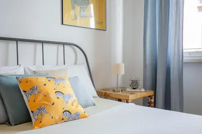 a bedroom with a bed and a table with a lamp at Perfetto per Famiglie Appartamento Accogliente e Spazioso a 15 min dalla Metro in Rome